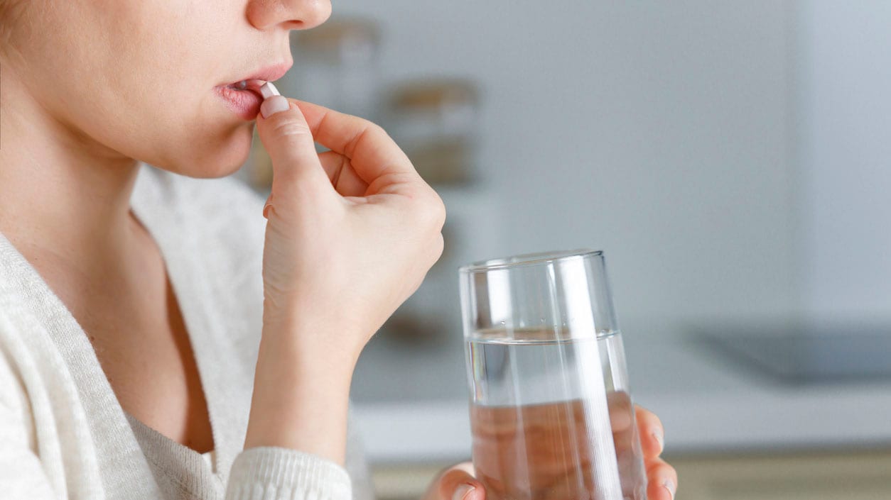 Woman taking a pill