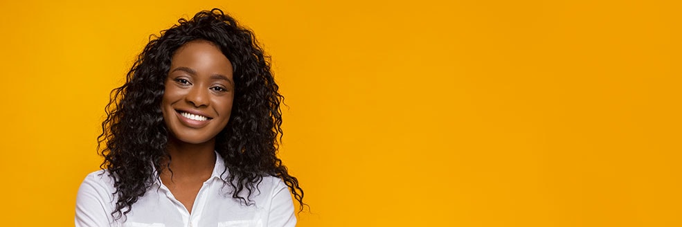 Confident smiling african american girl with crossed hands on chest