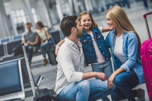 a family with their child ready to board a plane