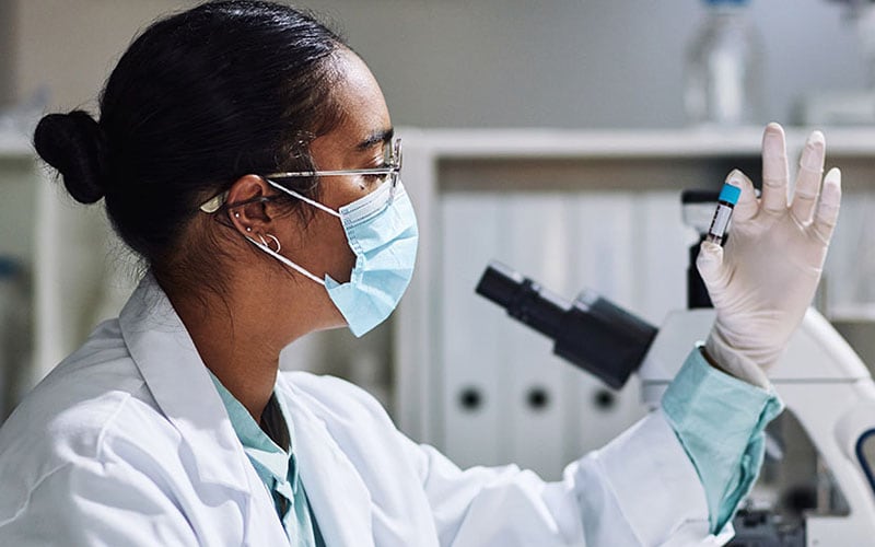 Lab Technician studies blood to look at the response of the immune system to vaccination or infections with pathogens.