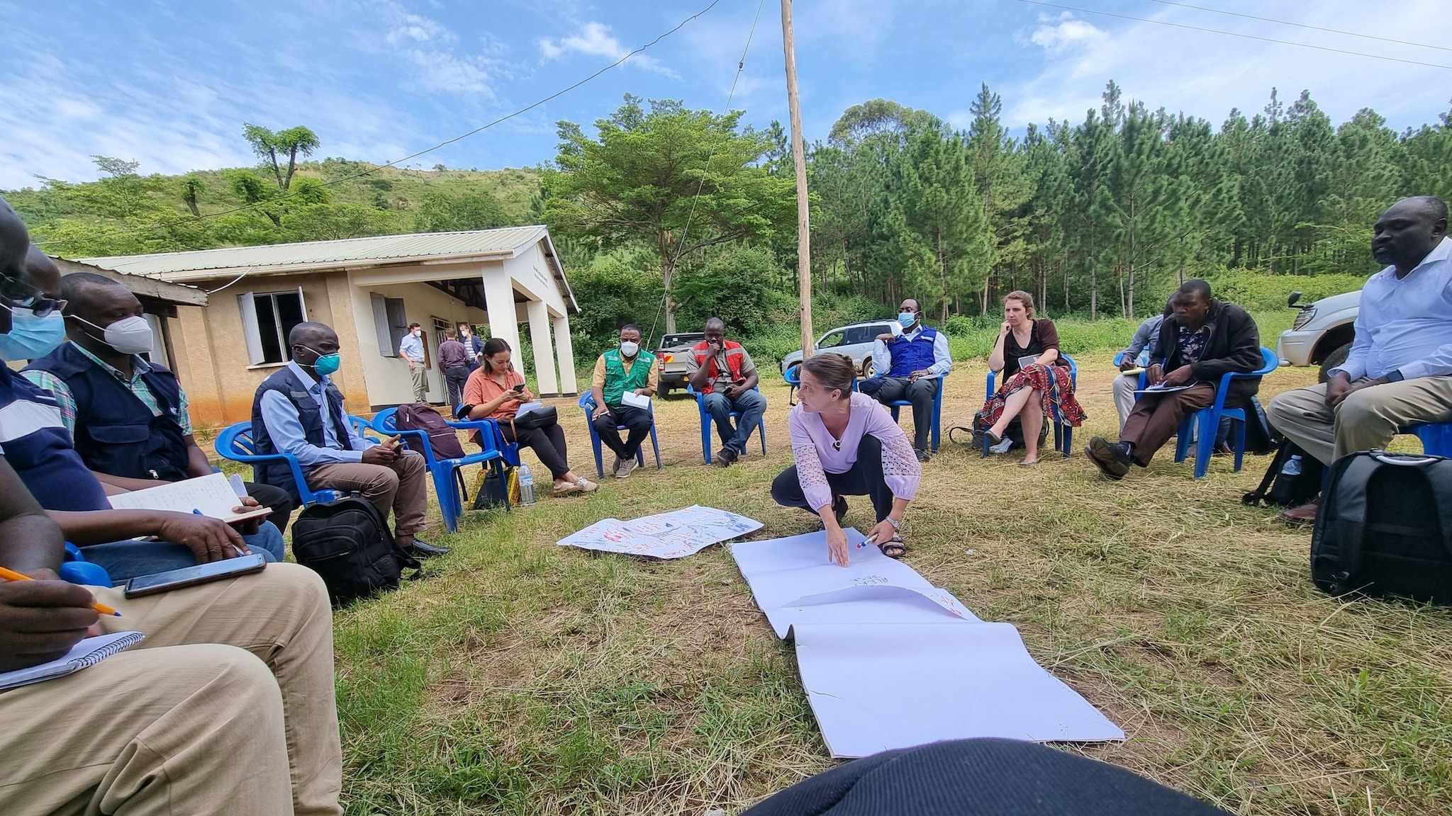 Dr. Amy Boore helps coordinate surveillance activities with partners in an outdoor meeting