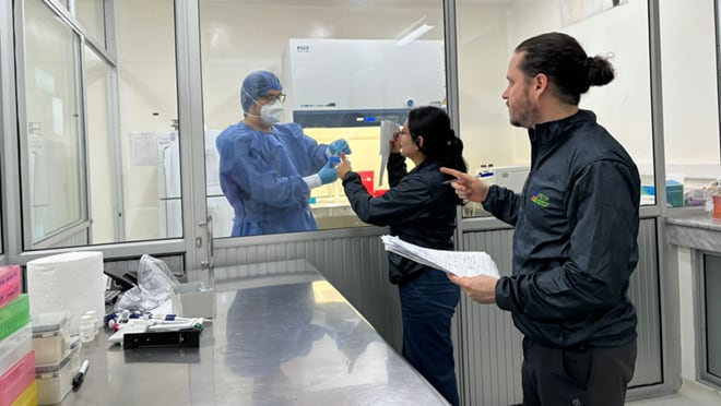 Three people in a laboratory.