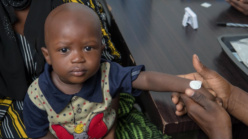 A young boy receives the measles microneedle patch vaccine.