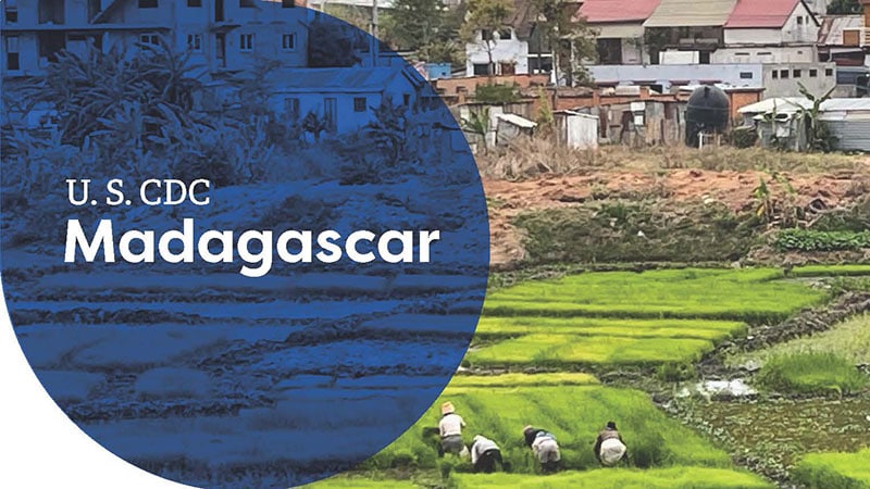 Workers in green rice fields with urban buildings in the background, labeled "U.S. CDC Madagascar."