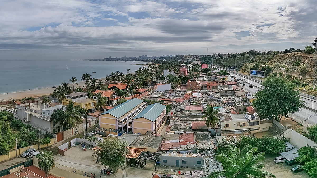 Aerial view at Luanda city downtown center with road, vehicles and buildings. View of the sky and coast.