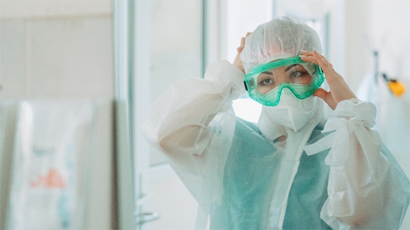 Photo of a lab worker wearing  personal protective equipment.