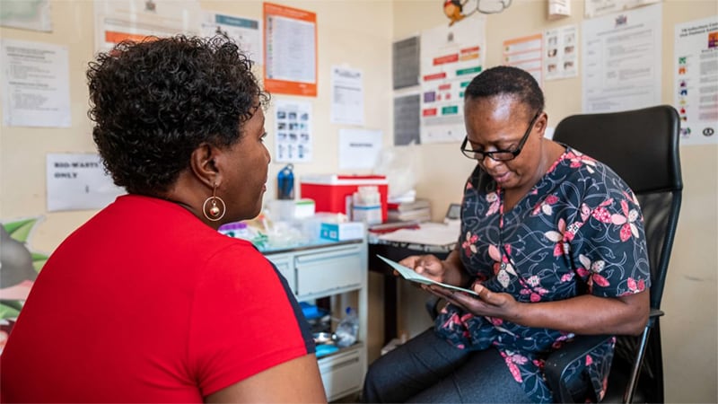 Patient and clinician discuss brochure in an office.