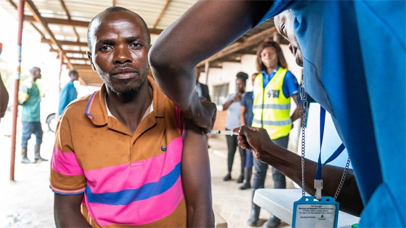 Photo of a man receiving a COVID-19 vaccine at a clinic.