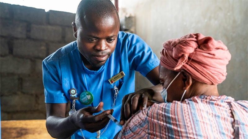 Health care worker provides vaccination to patient.