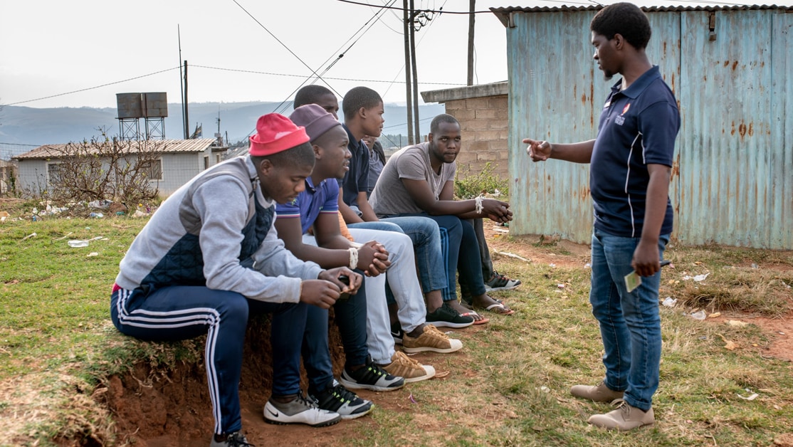 Counselor speaking to a group of young men