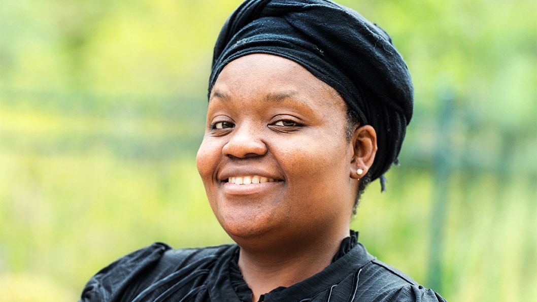 Portrait of a Jamaican woman smiling.