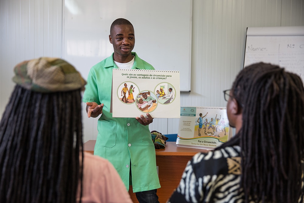 Men receive information on VMMC at a health clinic in Mozambique.