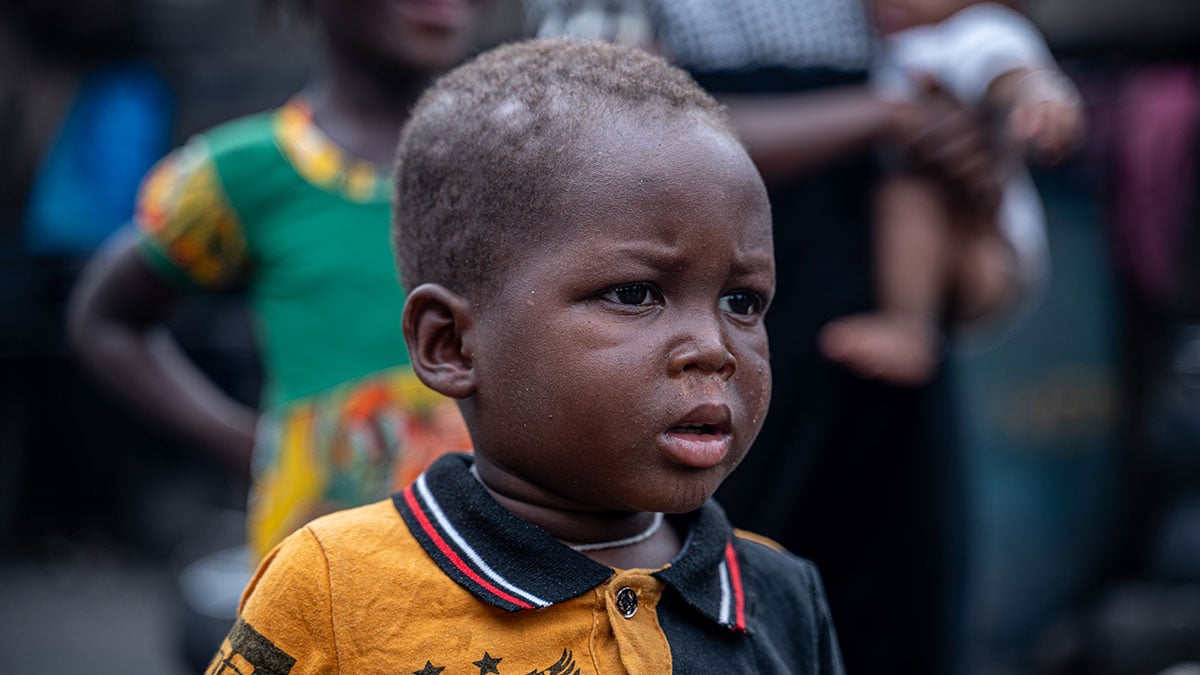 A little boy with a somber face.