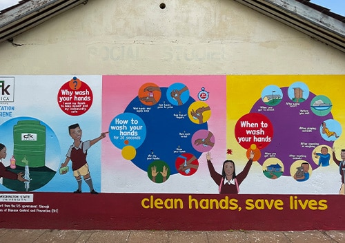 Mural on school building illustrating handwashing steps and encouraging students to practice hand hygiene. Nairobi, Kenya.