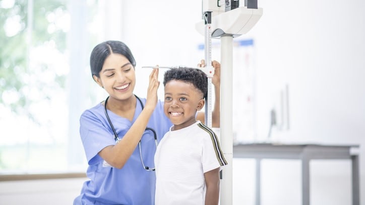 Nurse measuring a boy's height.