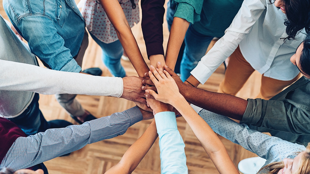 A group of individuals holding hands together