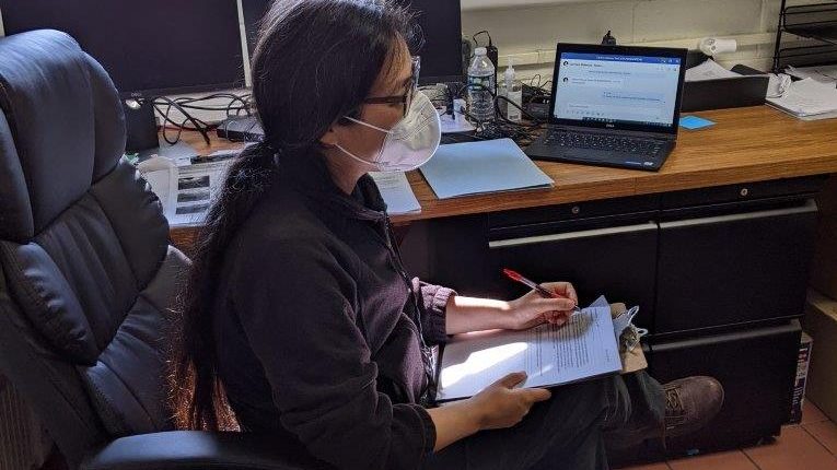 Woman working at a desk.