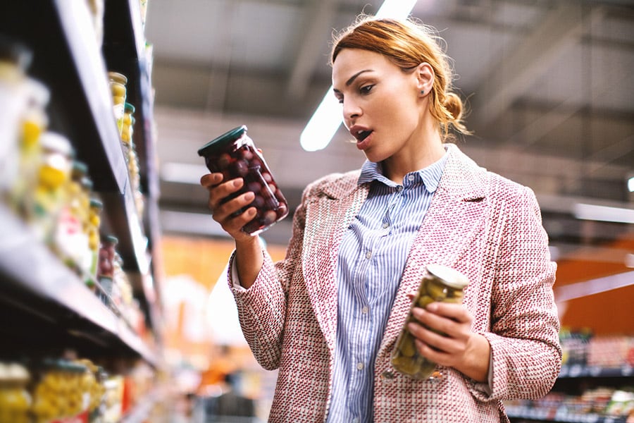 Woman buying food at grocery store.