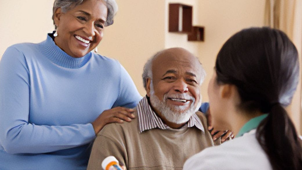 Older adults being counseled by a health professional.