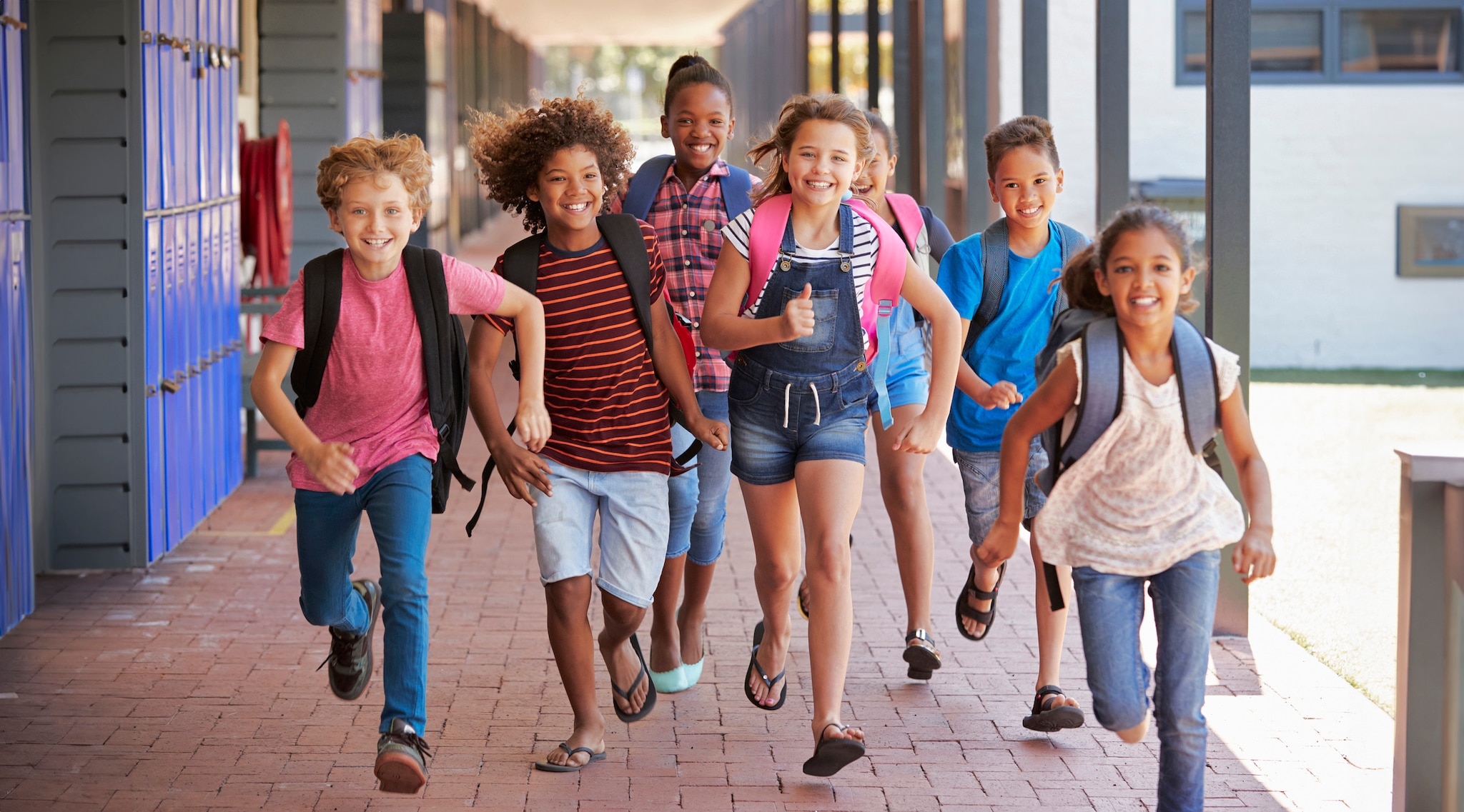 Children running outside of the school.