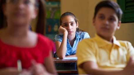 girl looking sleepy in class