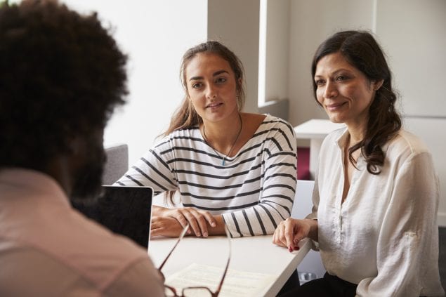 school nurse talks with student and her mother