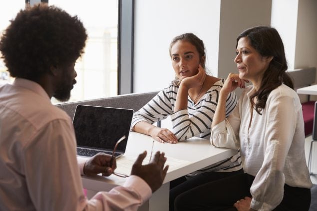 Mother And Daughter Meeting With Male Teacher