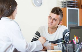 A school nurse talks with a student