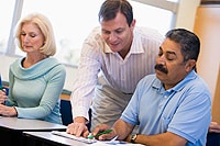 man teaching adults in classroom