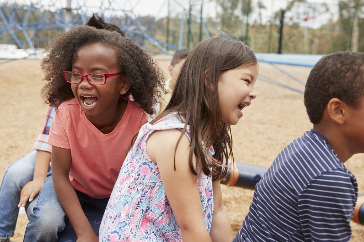 Elementary school kids playing in playground, close up