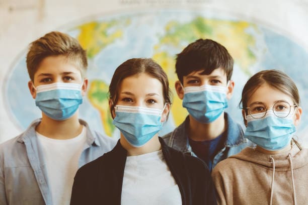 Group of teenagers in school wearing facemasks