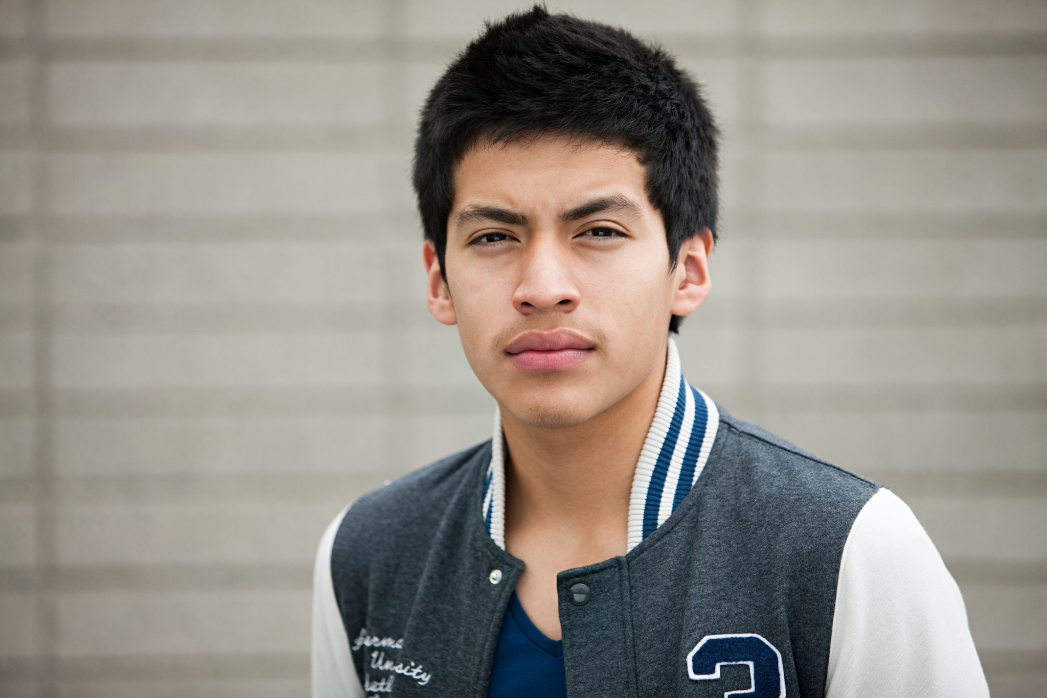 Young man wearing baseball jacket