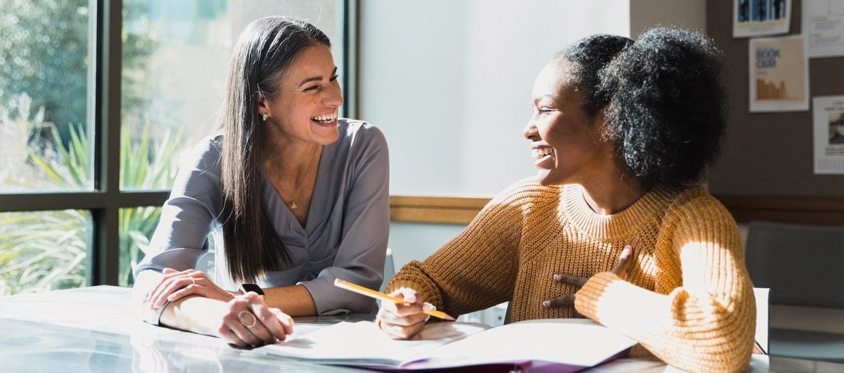 A female teacher talking with a female student