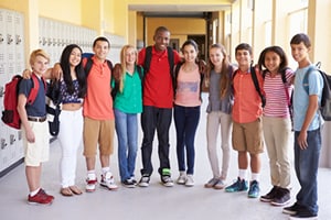 Group Of High School Students Standing In Corridor