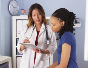 A Female nurse talking with a female student in clinic