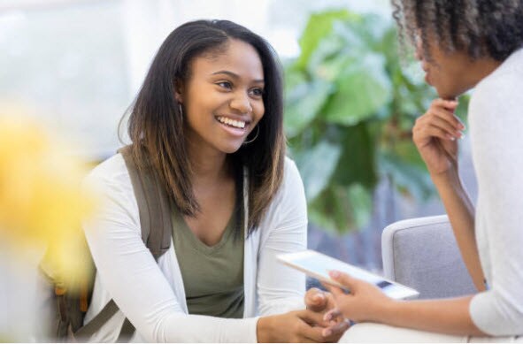 A female teen talking with school nurse