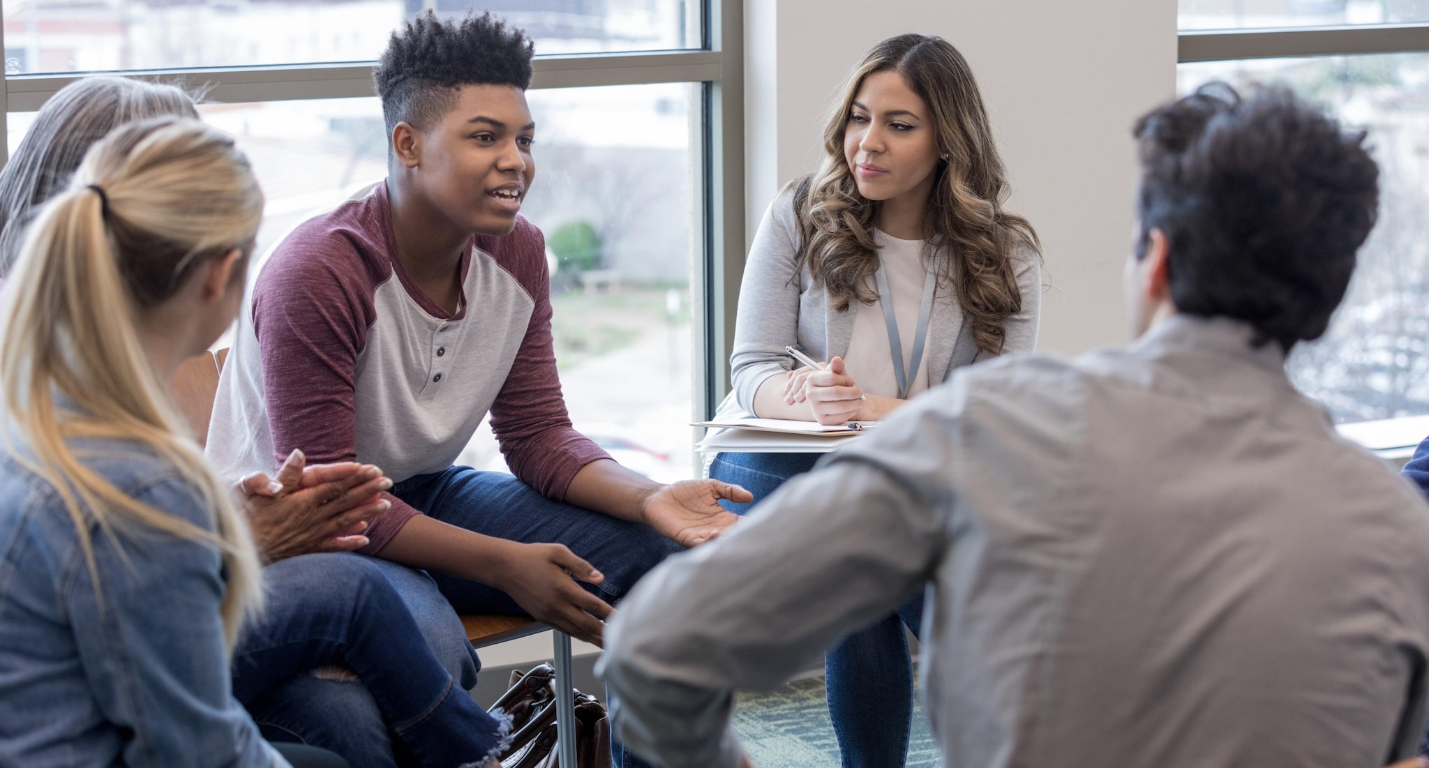 In therapy, teen boy shares life experiences with group