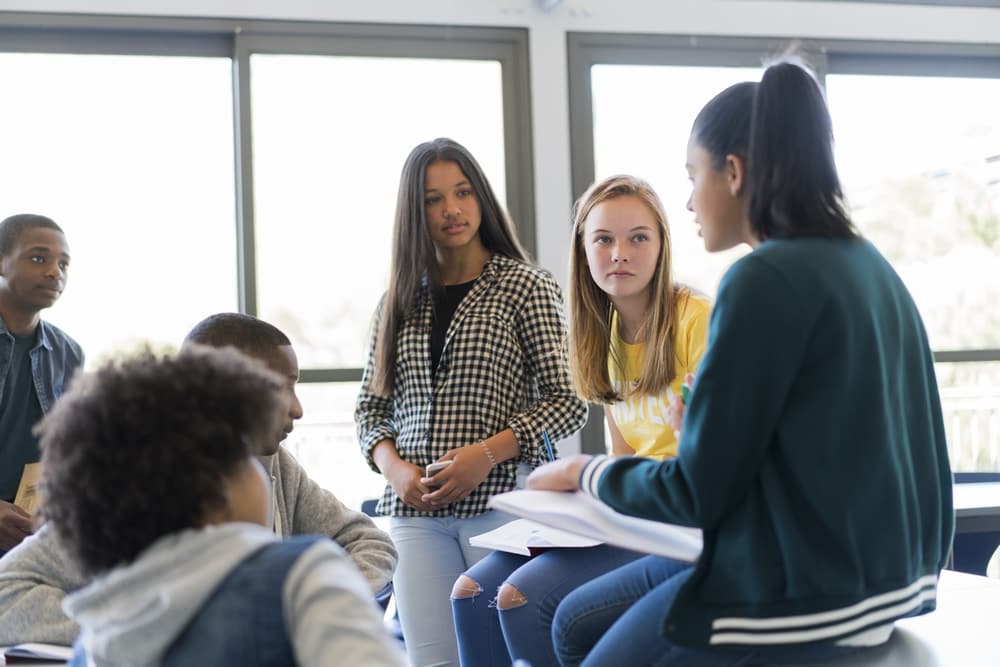 Multi-ethnic students discussing plan