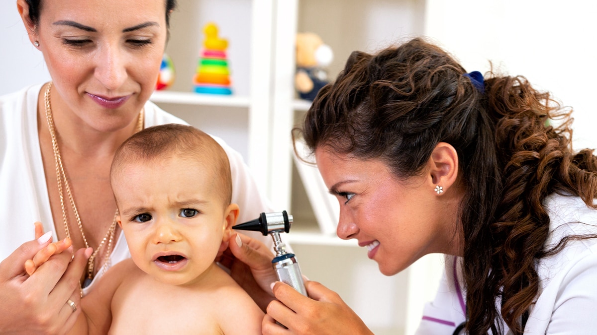 doctor checking newborn baby's hearing