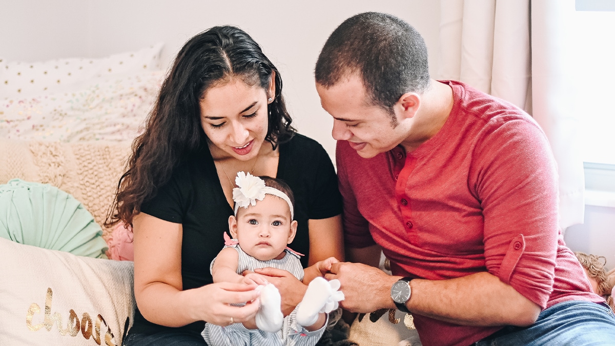 two parents with their daughter inside home