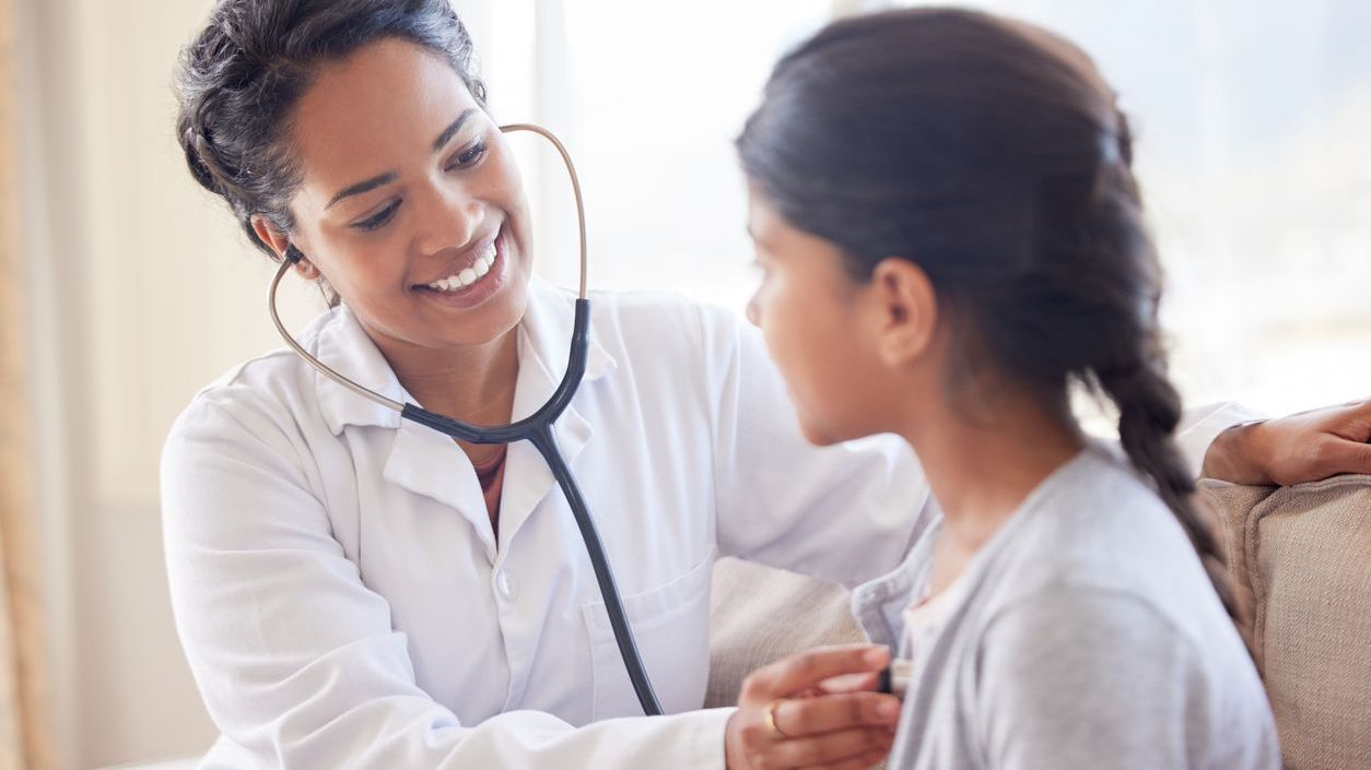 Doctor examining a little girl with stethoscope