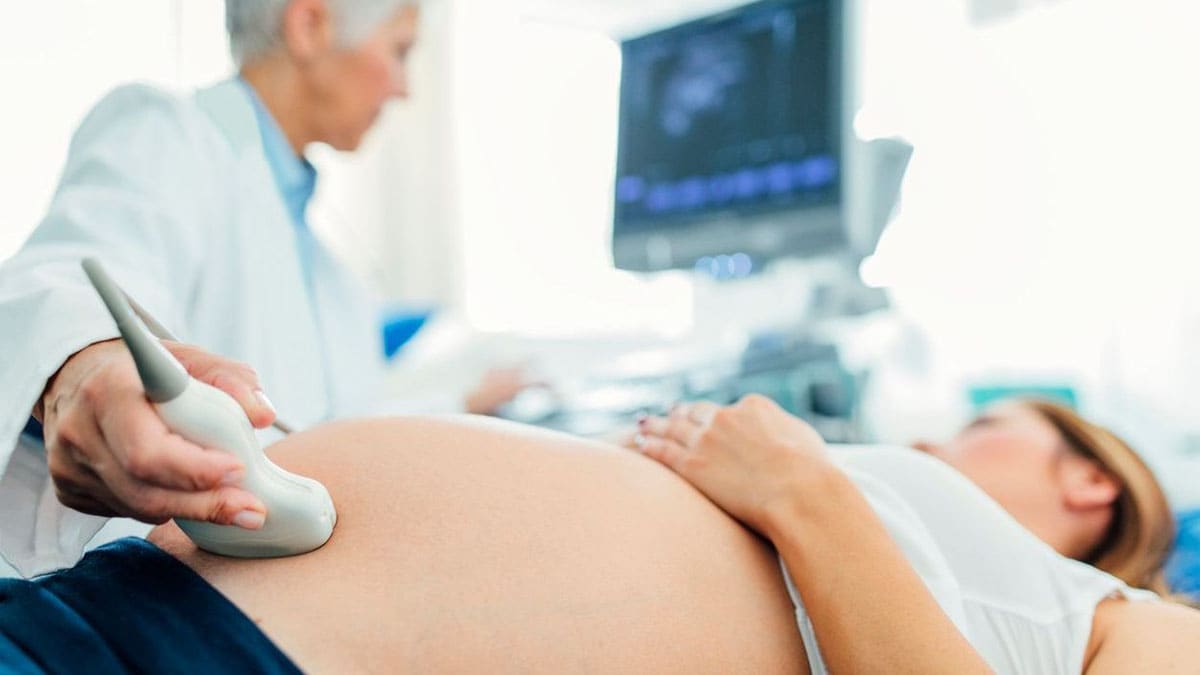 Doctor using ultrasound on a pregnant woman