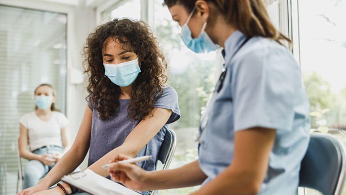 provider talking with a young patient.