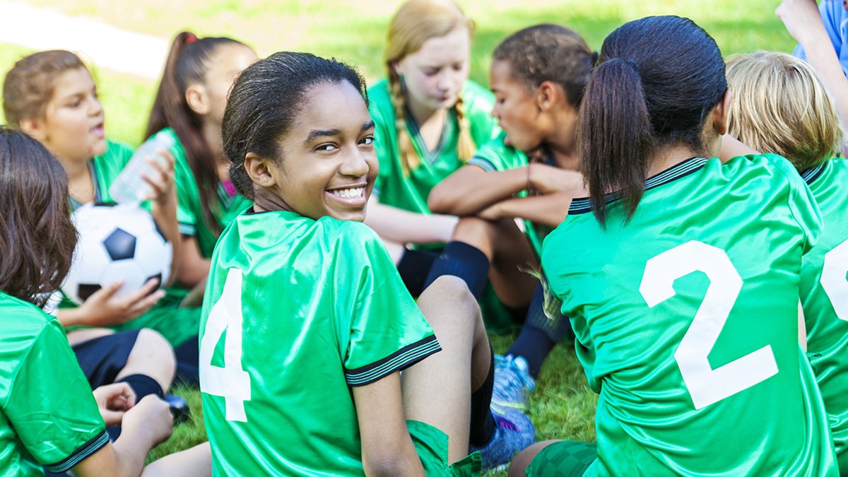 Girl smiling with her soccer team