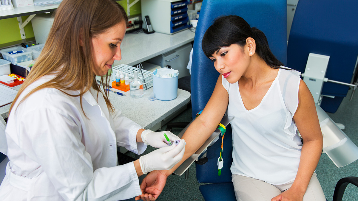 A doctor collecting a sample from a patient for medical testing