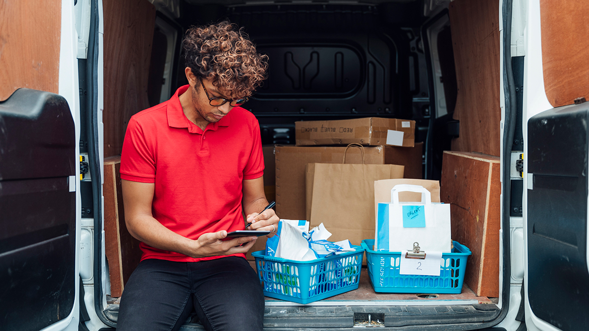 Healthcare professional sitting in their van reviewing hepatitis SSPs data on their phone