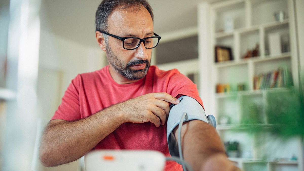 Man checking blood pressure at home.