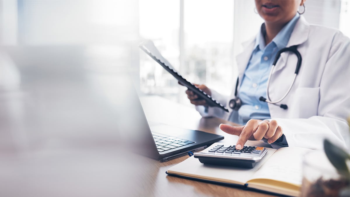 A doctor inputs patient information into a computer.