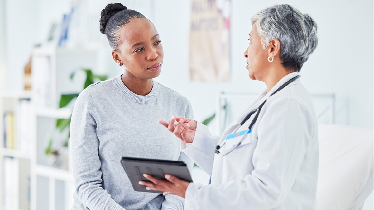 A doctor consults with a patient during an examination.