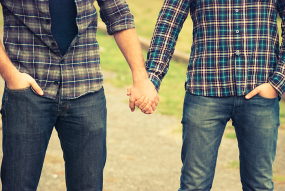 photo of two men holding hands